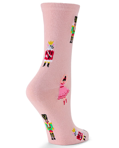 A single light pink crew sock with a repeating pattern of colorful nutcracker and ballerina figures, shown on a white background.
