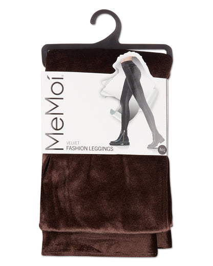 A pair of MeMoi velvet fashion leggings in dark brown, packaged on a black hanger with a white paper label showing the brand name and product details.