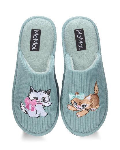 A pair of light blue ribbed slip-on slippers with plush lining and embroidered cartoon kittens on the front. The brand name 'MeMoi' is visible on black labels inside the soles.